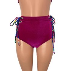 Our classic high waist hot pants with scrunch ruching detail in back to offer a "cheekier" look AND Lace-up sides! These hot pants are made of stretchy fuchsia velvet with splatter print ties and sit high on your natural waist. The lace-up sides make these more adjustable to fit you even better. Wear as a bikini bathing suit bottom, panties, rave shorts, etc. They have a built in liner and are made to be flattering to your figure. Trendy High Waist Bottoms For Pool, Tie-side Bottoms For Beach Season Parties, High Waist Beachwear Swimwear With Drawstring, High Waist Fitted Swimwear With Drawstring, Beachwear Bottoms With Drawstring For Festival, Fitted Tie-side Swimming Shorts, High Waist Drawstring Beachwear Bottoms, Beach Season Party Bottoms With Tie-side, Fitted High Waist Swimwear With Drawstring