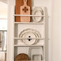 a shelf filled with dishes and plates in a kitchen