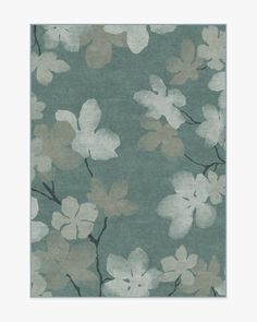 an area rug with flowers on it in blue and grey colors, including white leaves