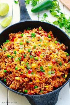 a skillet filled with rice and vegetables