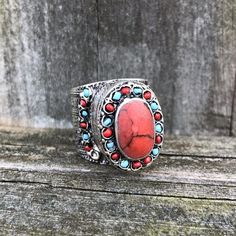 SKU: KJ-001Gemstone(s): Red Coral and TurquoiseRing Size: US 11This beautiful vintage tribal ring features a Red Coral oval cabochon, set in an ornate embossed ring that is decorated with tiny Turquoise and Red Coral beads. The ring is crafted from German silver. This is an authentic Kuchi tribal ring, made by the Kuchi tribes of Pakistan and Afghanistan. Due to the nature of natural crystals and gemstones and handmade nature of tribal jewelry, please understand that each piece is unique. Please Red Coral Ring, Coral Ring, German Silver, Coral Beads, Red Coral, Oval Cabochon, Crystals And Gemstones, Natural Crystals, Color Patterns