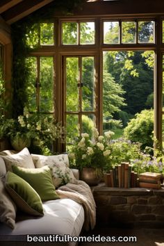 a living room filled with furniture and lots of windows covered in plants next to trees