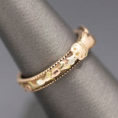 This is an exquisite Victorian wedding ring. The clasped hands open to reveal a secret band inside which could be used to hold the hair of a loved one or a very tiny message. The outside of the band is decorated with rose and yellow gold flowers. The band measures 3.84mm in width, and at the very base of the ring the outside is engraved with the letters J and E. Alas, this beauty cannot be resized. It measures just the tiniest bit short of a 7. It is crafted in 14k and weighs 2.66g. Victorian Wedding Ring, Letters J, Hands Open, Clasped Hands, Victorian Wedding, Gold Flowers, Antique Victorian, Wedding Ring, Wedding Rings