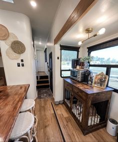 the interior of a mobile home with wood flooring