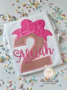 * A sweet birthday bodysuit or shirt for girls.   * The design is sewn with a number, bow topper and name of your choice * This is personalized with a name. (( Color changes are welcomed!  Send me a message First Birthday Crew Neck Top With Custom Print, Pink Custom Print Birthday T-shirt, Pink Birthday T-shirt With Name Print, Pink Crew Neck T-shirt For First Birthday, Fun Pink T-shirt For First Birthday, 1st Birthday Shirts, Children's Boutique, Birthday Shirts, Shirts For Girls