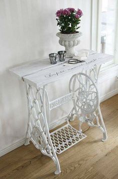 a white sewing machine table with flowers on top