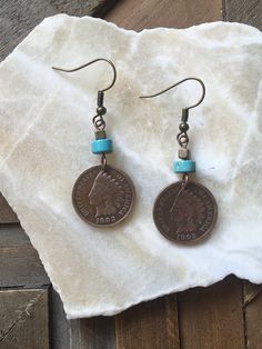 "Vintage Indian Head Penny Earrings, Copper Earrings, White Blue Turquoise Bead, Southwestern Style Jewelry ----------- Coin: Indian Head Penny Country: U.S.A. Date: various available Beautiful Indian Head Pennies are now hanging from these copper and turquoise earrings. Whether you're a coin collector, fan of southwest themed jewelry, or vintage items...you'll loves these unique earrings. These are genuine circulated coins that have some natural markings and patina. You will receive a random da Penny Earrings, Penny Jewelry, Copper And Turquoise, Southwest Jewelry, Indian Head, Message Jewelry, Vintage Indian, Coin Jewelry, Themed Jewelry