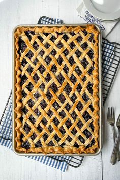 a pie sitting on top of a table next to silverware