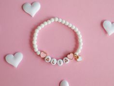 Kids Bracelet with Heart Charms and Natural White Stone Beads Adorn your child's wrist with our beautiful Kids Bracelet, featuring delicate colourful heart charms and natural white stone beads. This lovely accessory adds a touch of elegance and charm to any outfit, making it perfect for everyday wear or special occasions. Key Features: Heart Charms: Cute heart charms that symbolize love and friendship. Natural White Stone Beads: Elegant and durable, these beads add a touch of sophistication. The Valentine's Day Charm Bracelet With Letter Beads, White Beaded Bracelets With Heart Charm As Gift, White Stretch Bracelet With Heart Charm As Gift, Mother's Day Adjustable Heart Beads Charm Bracelet, Mother's Day Adjustable Charm Bracelet With Heart Beads, White Heart-shaped Jewelry With Letter Beads, Playful Heart Beads Jewelry For Birthday, Cute Beaded Bracelets With Heart Charm, Gift Beaded Bracelets With Letter Beads