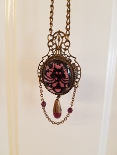 Beautiful purple multi faceted hand set medallion with an elaborate filigree border, crown, and backing. A drop chain in front includes 2 amethyst beads, and a 1" amethyst glass drop in an etched cap.   The adjustable chain that has a maximum 10" drop that can be adjusted to any shorter length by simply repositioning the hook to a lower link. The medallion, with the filigree top and drop chain measures about 4" in total length.  Grab this unique statement piece now to wear yourself or to give as a one of a kind gift to someone you know will love it. Filigree Border, Antique Medallion, Jewelry Wardrobe, Necklace Amethyst, Medallion Necklace, Amethyst Beads, Drop In, Faceted Glass, Jewelry Necklace Pendant