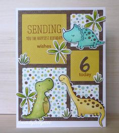 a birthday card with dinosaurs and flowers on it