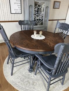 a dining room table with four chairs around it