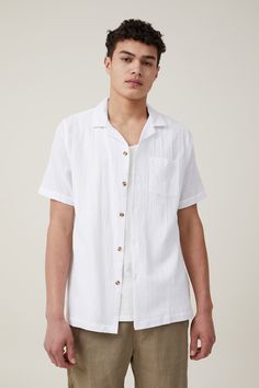 Features:  
- Short sleeve - Straight hem - chest pocket - button up - collared shirt White Short Sleeve Shirt With Spread Collar And Pockets, White Short Sleeve Shirt With Pockets And Spread Collar, White Cotton Johnny Collar Short Sleeve Shirt, Casual White Johnny Collar Short Sleeve Shirt, White Cotton Short Sleeve Shirt With Johnny Collar, Collared White Short Sleeve Shirt With Button Closure, White Cotton Shirt With Johnny Collar, White Camp Shirt With Button Closure And Relaxed Fit, White Camp Shirt With Spread Collar And Button Closure