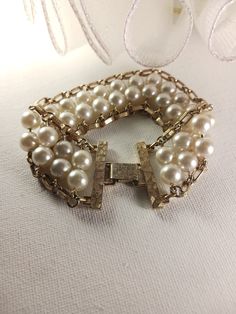 This vintage Pearl Flattery bracelet features faux pearl and gold tone chain link with a snap lock clasp. Sarah Coventry signed. This bracelet is in good vintage condition. Sarah Coventry signed Faux Pearl and Gold Tone Chain Link Bracelet, Vintage Wedding Jewelry, Bridal Reflections, SFV138   <-- BACK to my shop and please remember to admire my shop for further updates: https://www.etsy.com/shop/silverfeathervintage Thank you for your interest in Silver Feather Vintage! * Please carefully revie Formal Adjustable Pearl Chain Bracelet, Gold Metal Pearl Bracelet For Party, Classic Formal Pearl Chain Bracelet, Vintage Gold Bracelet With Chain, Vintage Pearl Bracelet For Formal Occasions, Vintage Gold Pearl Bracelet For Formal Occasions, Elegant Gold-tone Bracelets With Clasp, Gold Bracelet With Pearl Chain For Formal Occasions, Formal Gold Bracelets With Pearl Chain