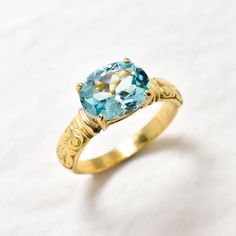 Gold Aquamarine Ring set with Created Aquamarine in a flawless diamond cut & stunning aqua color, 10x8mm, 3 Carats. Vintage Ring design made of Gold Vermeil ☞ thickest 18k Gold Plating on top of Solid 925 Sterling Silver ☞ made to last. Matching Earrings: www.etsy.com/listing/1042156632 Matching Pendant: www.etsy.com/listing/1082204850 ☞ Choose your size ☞ I resize (before shipping) for FREE to Any size* *Sizes 13-16 U.S. need to be custom made & May include an additional cost, I will contact you before starting to work on those custom-made sizes with all the details. Details :  ♥ Each item comes in a cute GIFT BOX ✓ ♥ GUARANTEE on the materials ✓ ♥ Created Aquamarine Ring in a perfect diamond cut & flawless clarity ✓ ♥ Pure Solid 925 Sterling Silver ☞ Silver Hallmark on each piece ♕ ♥ 18K Gold Aquamarine Ring, Aqua Pendant, Aquamarine Ring Vintage, Diamond Ring Gold, Flawless Diamond, Blue Diamond Ring, Real Jewelry, Aquamarine Ring, Ring Blue