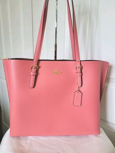 NWOT COACH MOLLIE TAFFY PINK LEATHER LARGE TOTE  SHOULDER BAG HANDBAG SATCHEL $378. Pebble leather Inside multifunction pocket Zip-top closure, fabric lining Handles with 10 1/4" drop Side open compartments 13 1/4" (L) x 11" (H) x 5" (W) Style No. 1671 New without Tags!!! Coach Mollie, Taffy, Large Tote, Pink Leather, Pebbled Leather, Bags Handbags, Satchel, Shoe Accessories, Handles