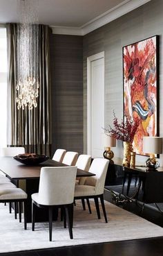 a dining room table with white chairs and chandelier