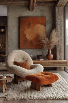 an orange and white chair sitting in front of a painting on the wall next to a coffee table