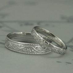 This is a wonderfully lovely set for a wonderfully lovely couple! It features a vintage style design with a modern twist to it. Cast in solid 14K gold, it features a swirling design around the entire outer surface. The wider band measures 5.5mm wide by 1.5mm thick. It features a lovely milgrain edge. The thinner band measures 3.5mm wide by 1.5mm thick and features the matching design without the edge. These are quality solid gold rings to last you a lifetime and then some! Your rings can be cast White Sterling Silver Engraved Wedding Ring, Gold Sterling Silver Couple Rings For Wedding, Formal White Wedding Jewelry With Intricate Design, Traditional Engraved White Gold Ring For Wedding, Anniversary Bridal Sets With Intricate Design In Silver, White Engraved Jewelry For Wedding, Traditional Wedding Ring With Intricate Engraving, Traditional White Gold Engraved Wedding Ring, Traditional Engraved Wedding Ring With Intricate Design