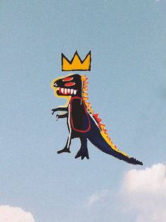 a kite shaped like a dinosaur with a crown on it's head flying in the sky