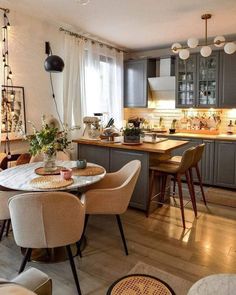 a kitchen and dining room area with chairs