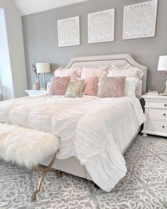 a white bed sitting in a bedroom on top of a rug