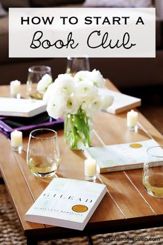 a table with books and wine glasses on it that says how to start a book club