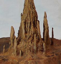 a rock formation in the desert with trees growing out of it