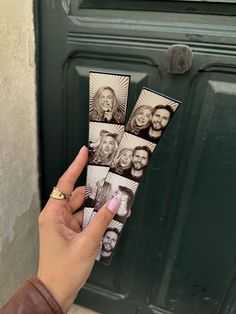 a person holding up four pictures of people in front of a door with their faces on them