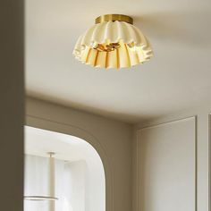 a light that is on the ceiling in a room with white walls and flooring