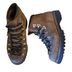 two pairs of brown boots with laces and studding on the sides, side by side