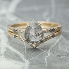 an engagement ring with a pear shaped diamond in the center