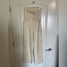 This Item Is New With Tags. However It Has Small Stain On Front And At Bottom Hem Of Legs. High Waist Cotton Strapless Jumpsuit For Summer, Summer Cotton Strapless Jumpsuit With High Waist, High Waist Strapless Cotton Jumpsuit For Summer, High Waist Fitted Utility Jumpsuits And Rompers, Fitted High Waist Utility Jumpsuits And Rompers, Fitted High Waist Denim Jumpsuit In Utility Style, Fitted High Waist Denim Utility Jumpsuit, Strapless Jumpsuits And Rompers With Pockets For Spring, Strapless Cotton Jumpsuits And Rompers For Spring