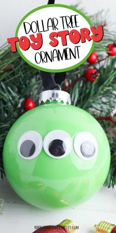 a green christmas ornament with googly eyes and a sign that says dollar tree toy story ornaments