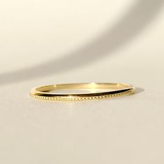 One piece of everyday durable, milgrain stacker ring handcrafted in 14K solid gold. It is the ESSENTIAL ring for your treasure box. Ships within 3 business days. - Band width: 1.1mm - Band thickness: 1.3mm - Made in 14 karat gold. - Stamp with 14K. Milgrain Ring, Stacker Rings, Treasure Box, Treasure Boxes, Stacking Rings, Gold Beads, Solid Gold, Wedding Rings, Stamp