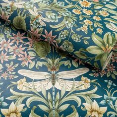 an image of a blue floral wallpaper with dragonflys and flowers on it