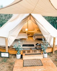 the inside of a tent that is set up for people to stay in and relax