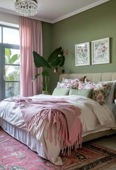 a bedroom with green walls, pink curtains and a large bed in the center of the room