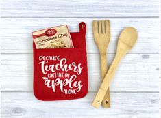 a wooden spoon and fork are next to a red pouch