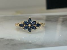 a gold ring with blue and white stones