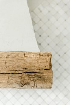 a piece of wood sitting on top of a white tiled floor