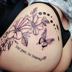 a woman's thigh with flowers and butterflies on it, saying say yes to heaven