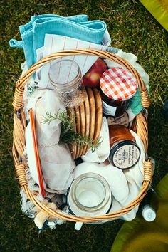 a picnic basket filled with food and drinks