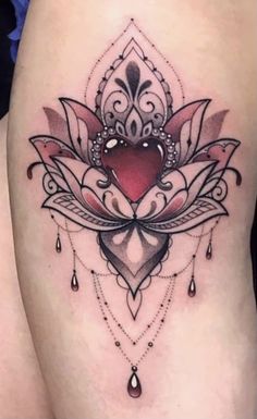 a woman's thigh with a heart and lotus tattoo on the side of her leg