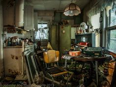 an old kitchen filled with lots of clutter and junk on top of the floor