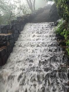 the water is running down the steps in the waterfall that leads up to the top