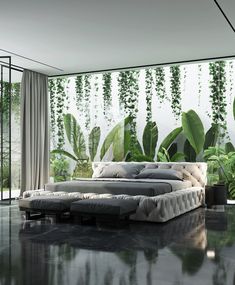 a large bed sitting in the middle of a room next to a plant covered wall