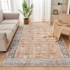 a living room with a couch, chair and rug