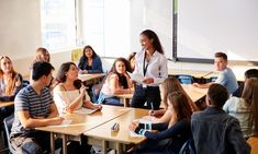 a group of people sitting at desks in a classroom