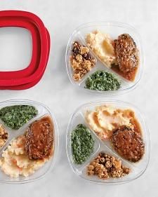 four plastic containers filled with different types of food